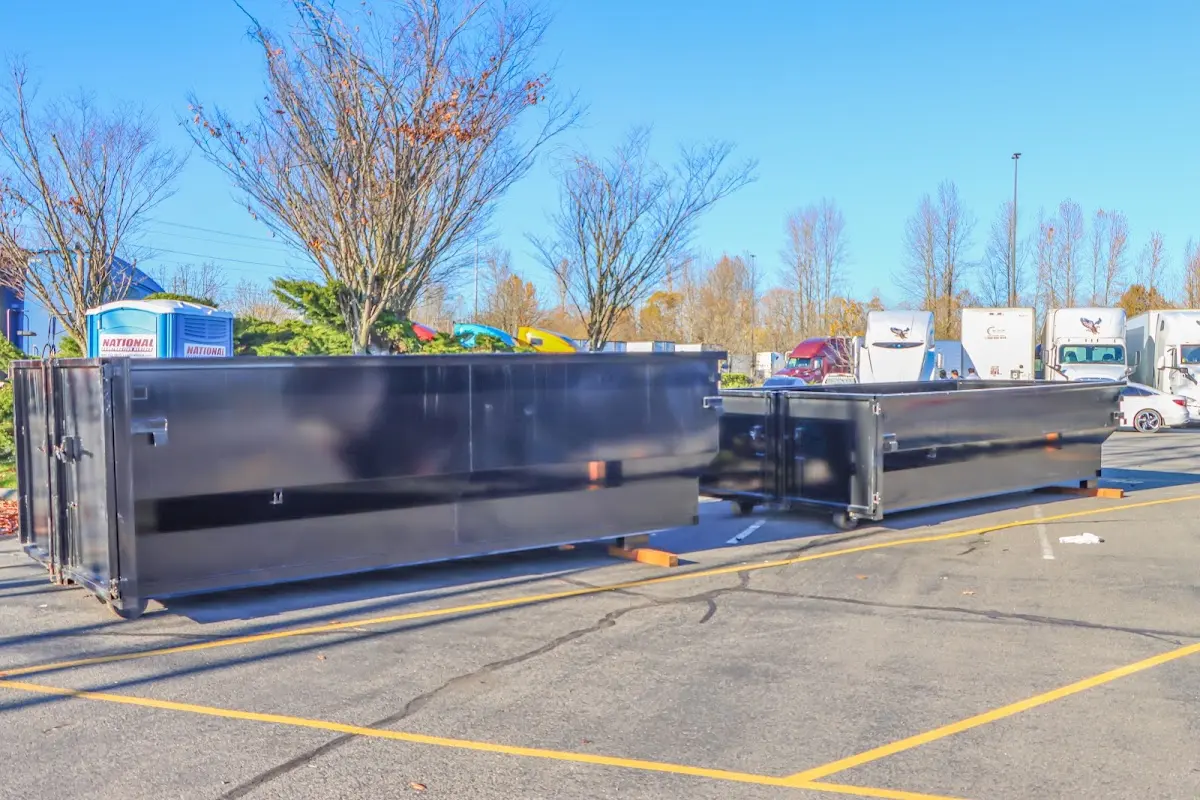 Professional dumpster rental service with roll-off container on residential driveway in Fountainhead-Orchard Hills